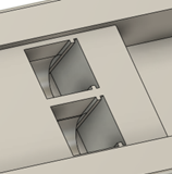 A CAD render of the musical grasping training aid with the slots for two battery contact plates visible.